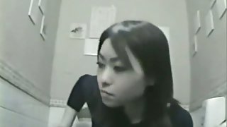 Nice asian woman is caught on camera while pissing in toilet